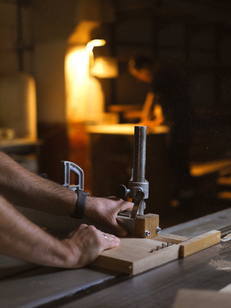 Craftsman hand-planing timber in the workshop